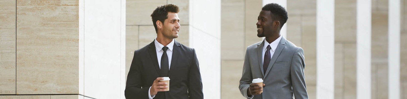 Lawyers talking and drinking coffee in front of a courthouse