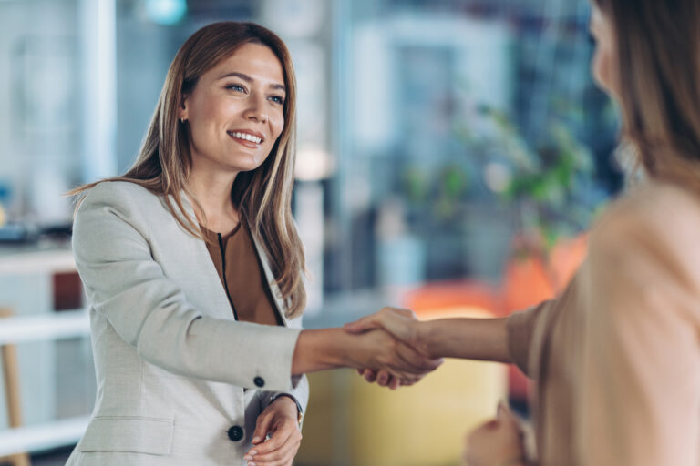Businesswomen shaking hands in the office