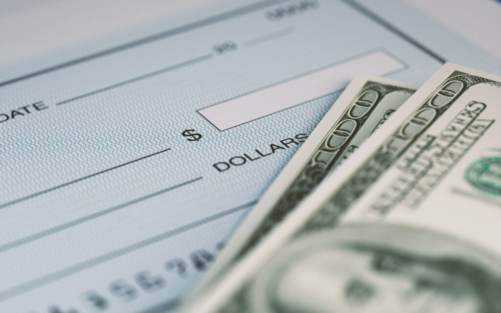 Personal Check and American Dollars With Selective Focus