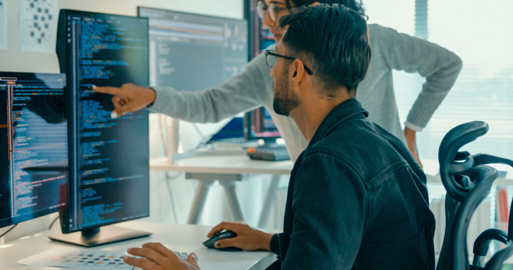 Tech team professionals collaborate discuss software development strategies in modern office. Software developer, artificial intelligence and programming.