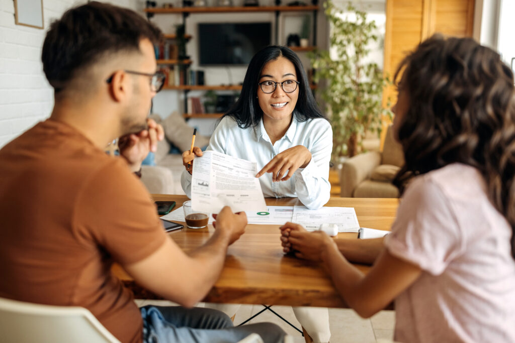 Young financial planner helping couple with their money management skills