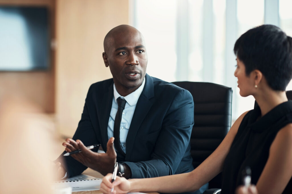 Black man, leadership and corporate meeting in office with executive management, investor feedback and strategy. Professional business manager, team discussion and CEO in financial investment seminar