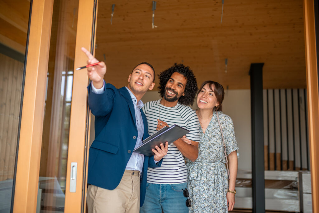 Diverse Couple Exploring Home with Hispanic real estate agent