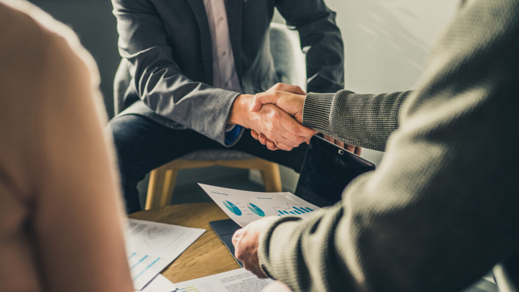 Advisor shaking hands with client